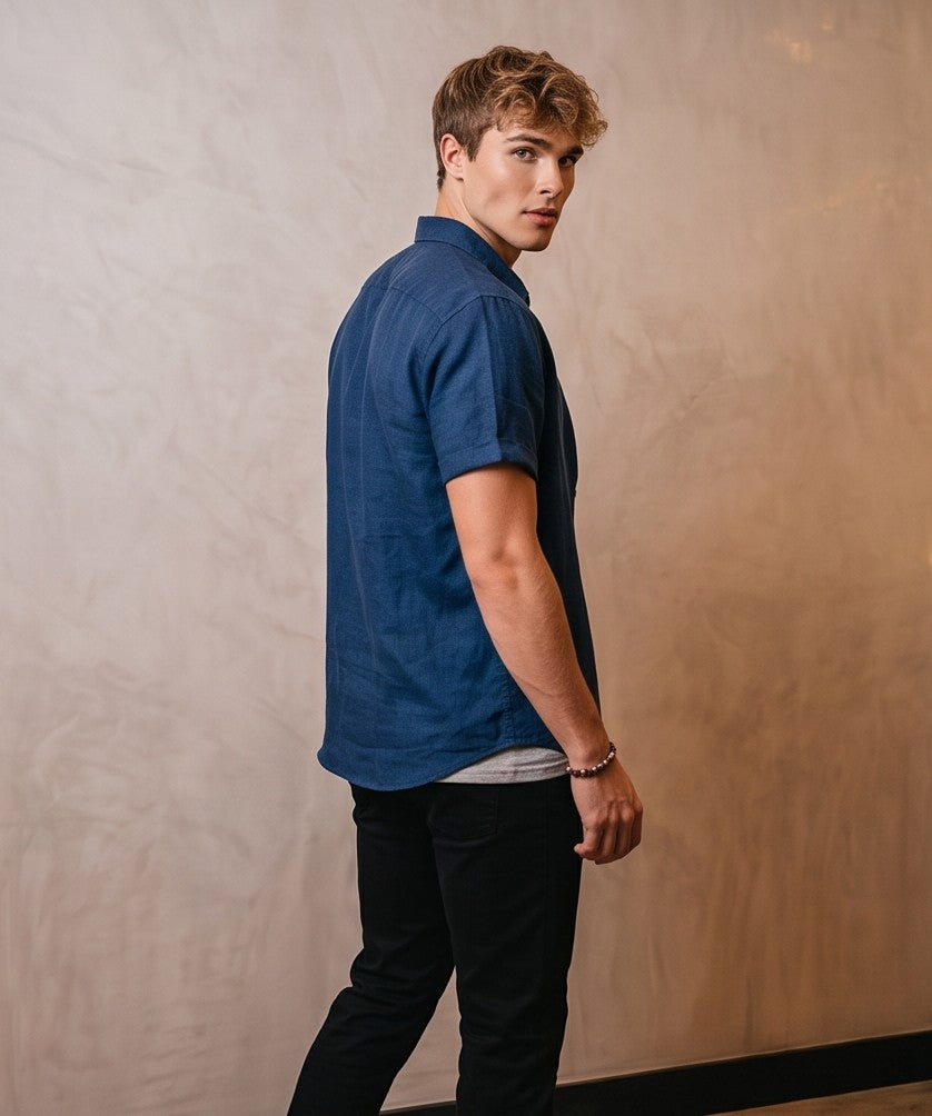 Camisa de lino y algodón para hombre de corte regular fit y manga corta con dobladillo, cuello cubano con solapa y cierre abotonado frontal, confeccionada en tejido transpirable disponible en 7 colores lisos: verde oliva, negro, gris marengo, azul marino, blanco puro, azul celeste y rosa palo.