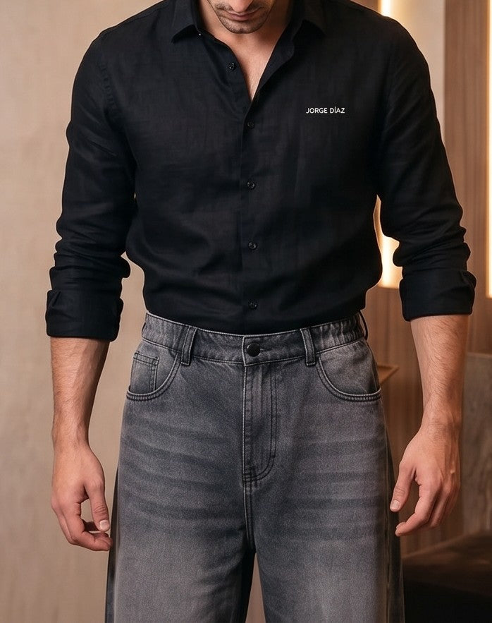 Pantalón vaquero de corte ancho y tiro medio en tono azul claro con efecto desgastado, costuras verticales decorativas en las piernas y detalle de cintura elástica en la parte trasera.